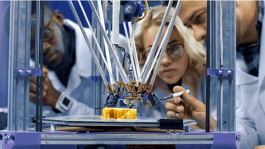 Group of workers in a lab examining a project