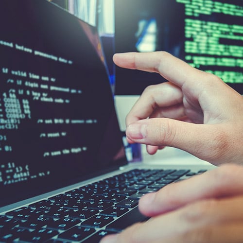 A person at a tech company in Costa Rica pointing at a computer